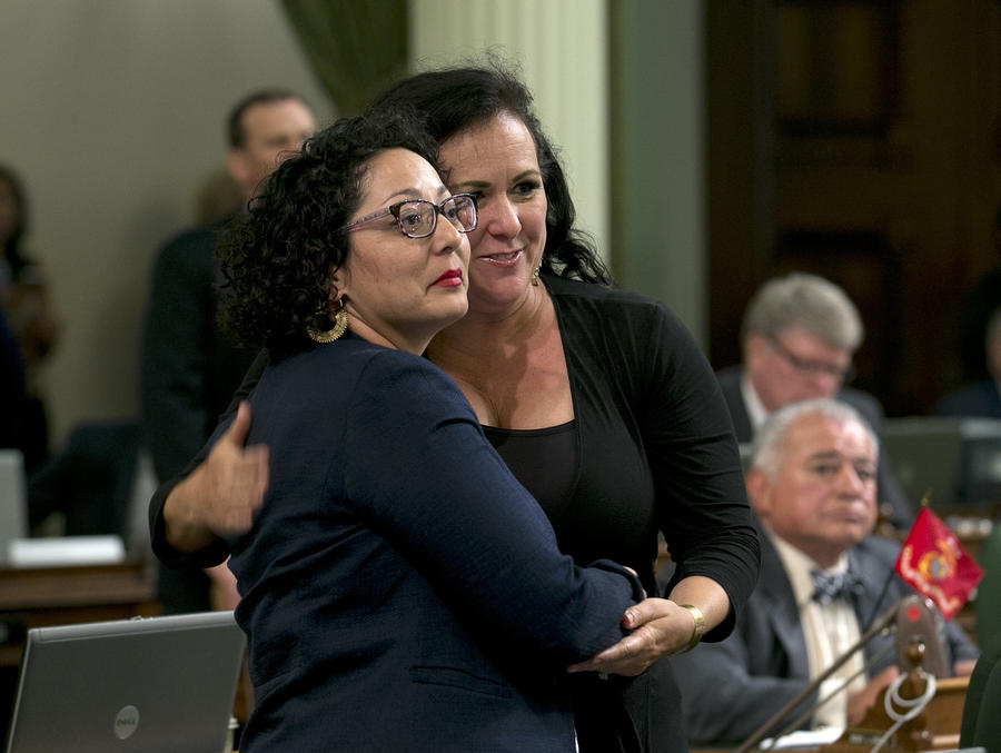 Democratic Assemblywomen Cristina Garcia, of Bell Gardens, left, and Lorena Gonzalez-Fletcher, of San Diego, watch as the votes are posted for Garcia's climate change bill on Monday in Sacramento. — Photograph: Rich Pedroncelli/Associated Press.