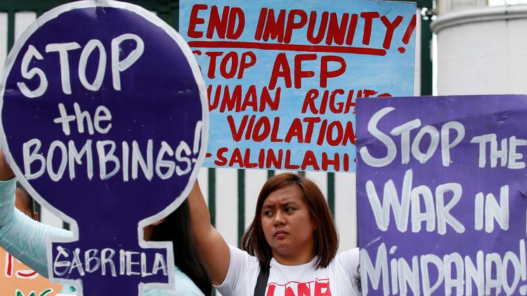 Demonstrators in Manila on July 7 protest Philippine President Rodrigo Duterte's declaration of mart