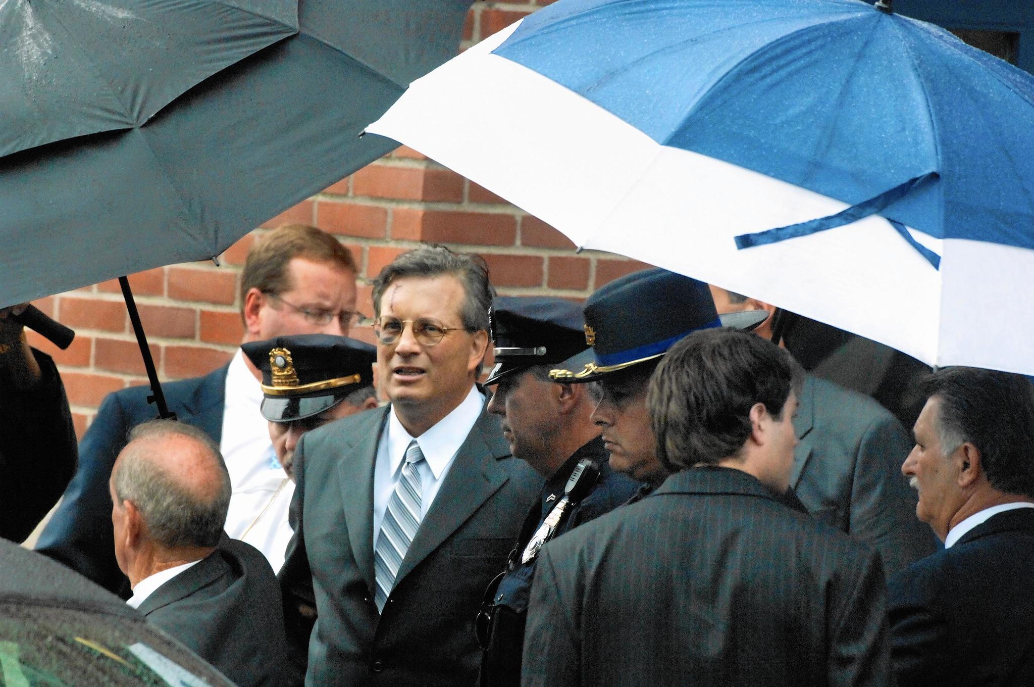 William Petit is escorted to his limousine after a public memorial service for his wife, Jennifer Hawke-Petit, and their two daughters, Hayley and Michaela, at Welte Auditorium on the campus of Central Connecticut State University in 2007.