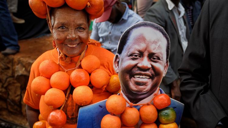 A supporter of opposition presidential candidate Raila Odinga flaunts oranges, the party's symbol, a