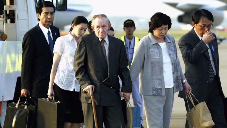 Charles Robert Jenkins and his wife, Hitomi Soga, arrive in Tokyo on July 18, 2004. They were forced