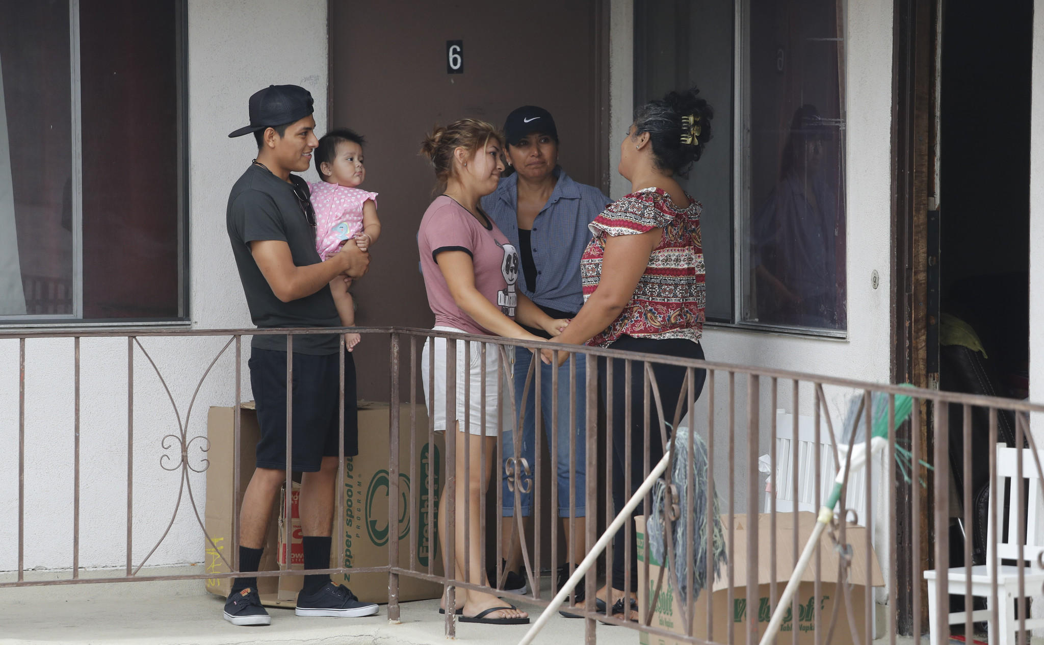 Maria Barrancas, right, bids farewell to neighbors on her family's last day in the United States.