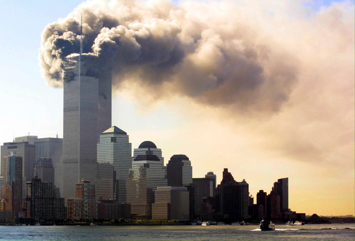 Smoke billows from the top floors of the World Trade Center towers.