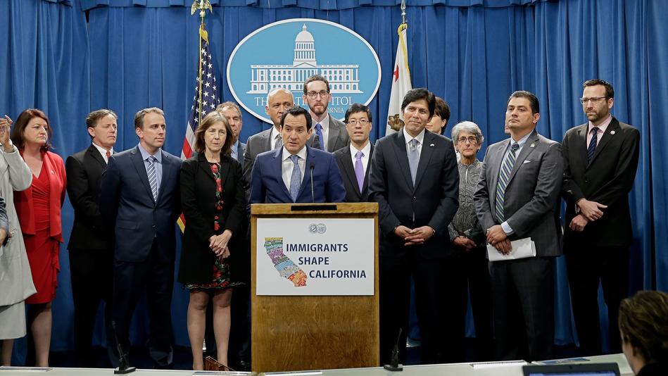 Assembly Speaker Anthony Rendon (Democrat-Paramount), center, and Democratic lawmakers discuss proposed measures to protect immigrants during a December 2016 news conference in Sacramento. — Photograph: Rich Pedroncelli / Associated Press.