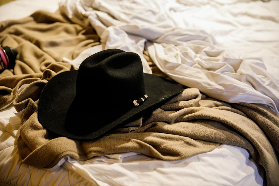 Brian MacKinnon retrieved Adrian Murfitt's new cowboy hat and took it back to their hotel room. — Photograph: Marcus Yam/Los Angeles Times.