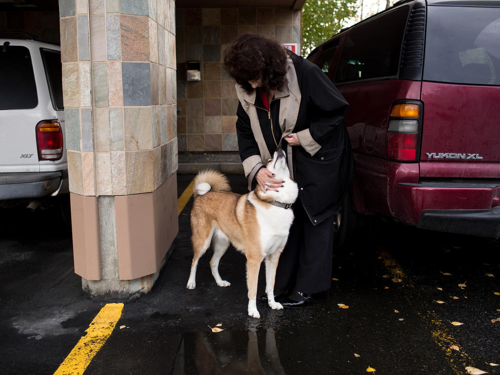 Avonna Murfitt takes her son's dog for a walk outside the office where she works as a paralegal in Anchorage. — Photograph: Ash Adams/Los Angeles Times.