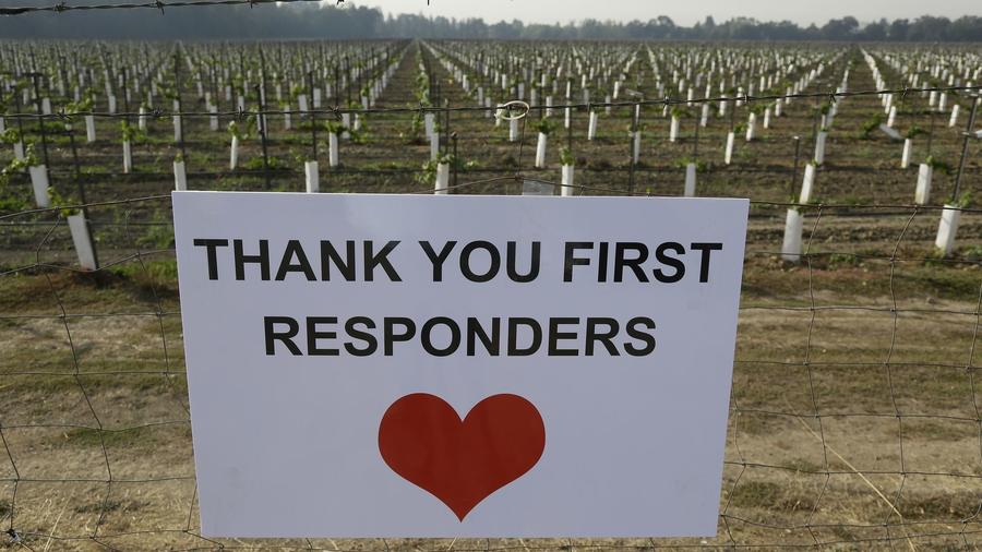 A sign thanking first responders hangs by a newly planted vineyard Monday, Oct. 16, 2017, in Napa, C