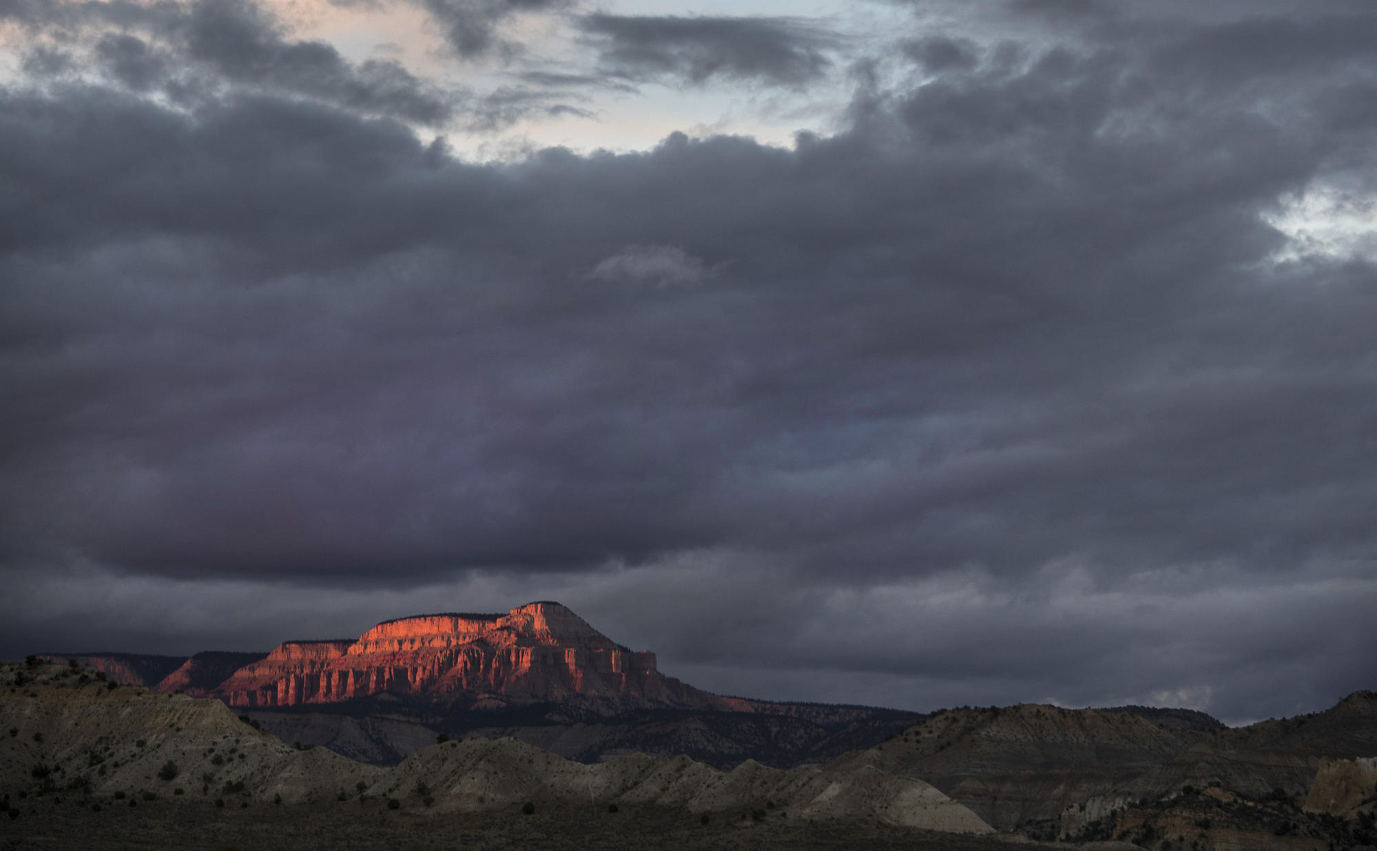 Light from a fading sunset bathes 10,188-foot Powell Point in a view from state Highway 12 near Tropic, Utah, in Grand Staircase-Escalante National Monument.