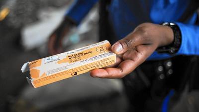 A Philadelphia police officer shows a package of the overdose reversal agent Naloxone Hydrochloride, or Narcan, while on patrol near a heroin encampment in the Kensington neighborhood of Philadelphia on April 14, 2017.