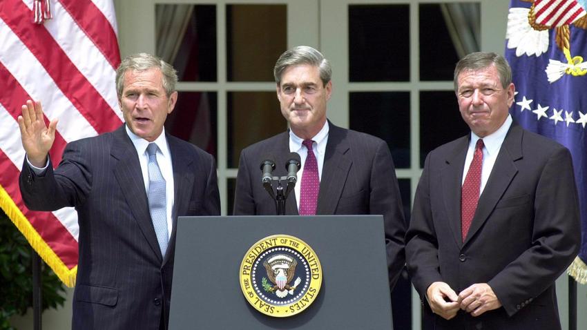 President George W. Bush waves on July 5th, 2001 after announcing Robert Mueller as his choice for FBI director. On the right stands then-Attorney General John Ashcroft.  Photograph: Emilie Sommer/Agence France-Presse.
