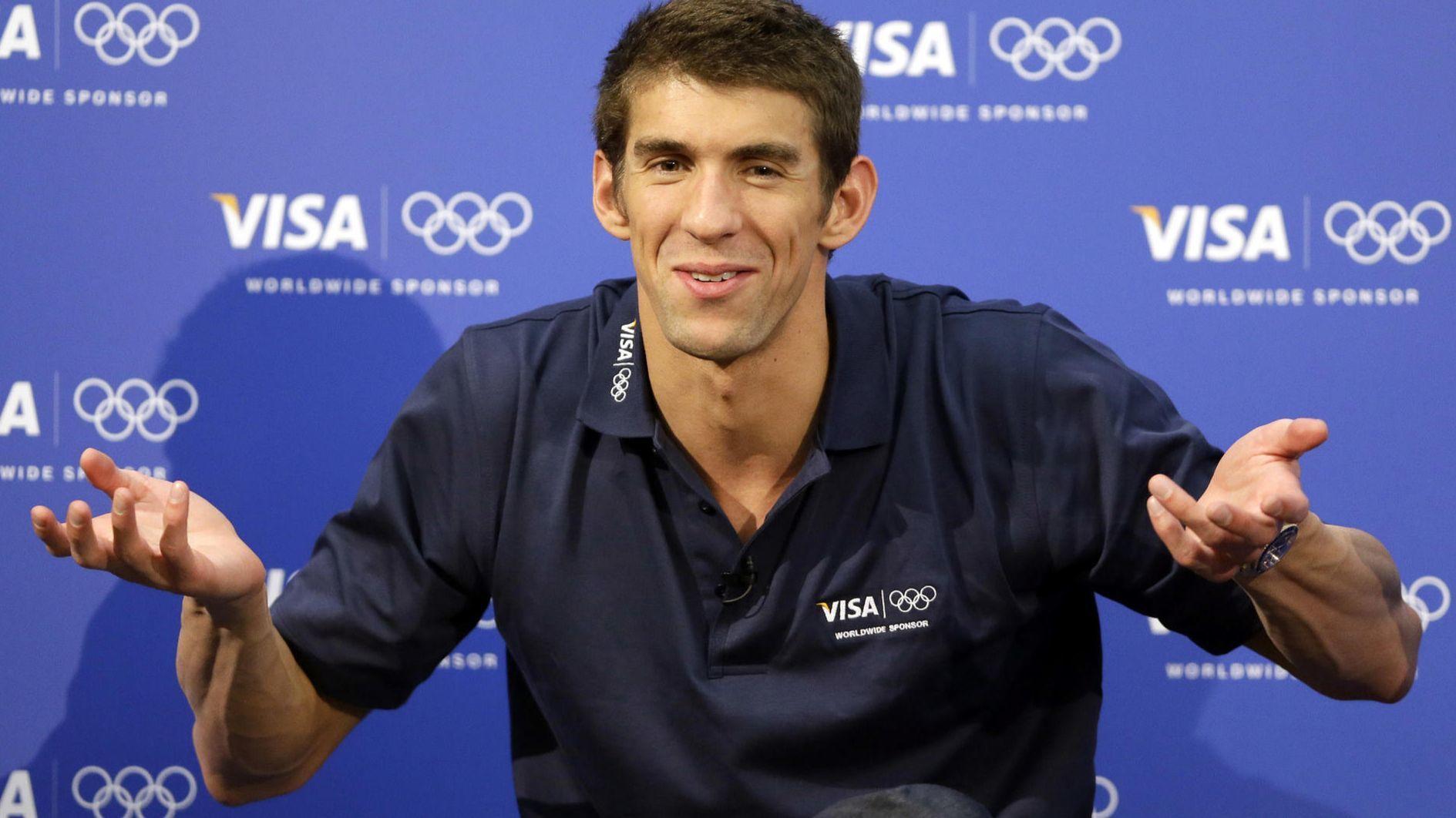 USAs Michael Phelps stands on the podium after winning 