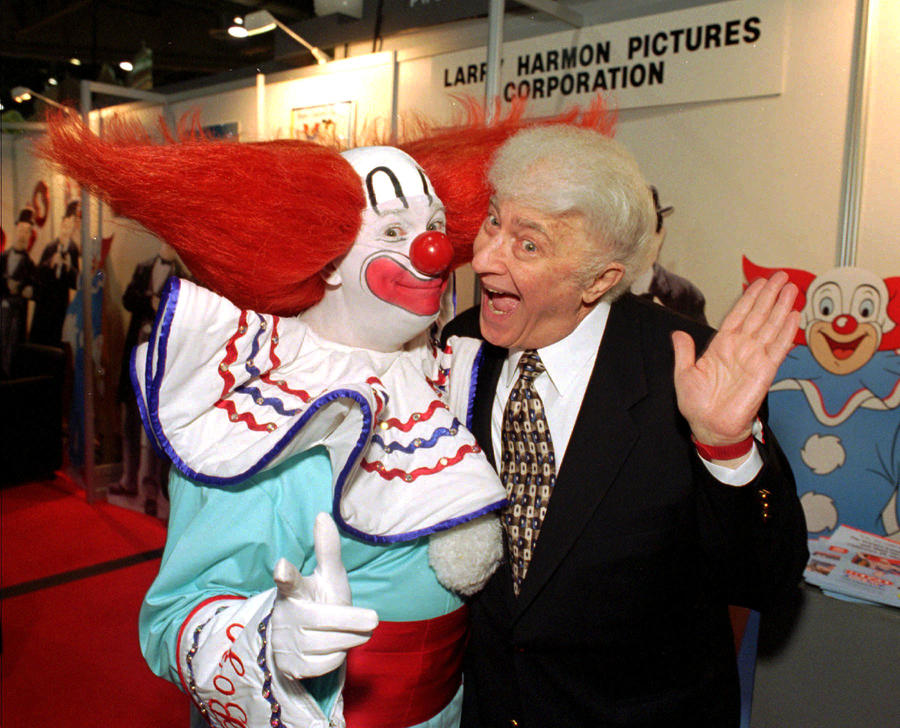 Bozo the Clown, seen here with Bozo franchise mastermind Larry Harmon, was a children's entertainment staple for decades. (Lennox McLendon / Associated Press)