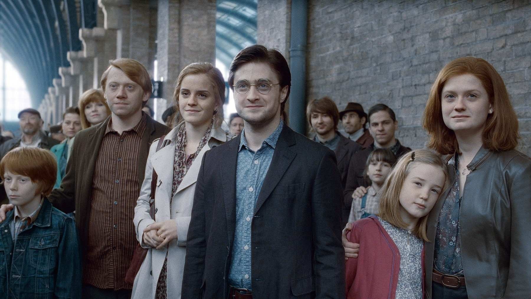 Ron, Hermione, Harry, and Ginny watch their children go off to Hogwarts in the final scene of the Harry Potter film franchise. 