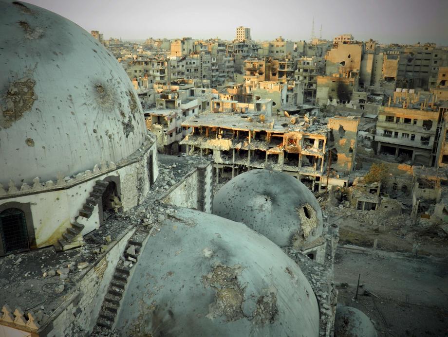 In Homs, the partially destroyed Khalid bin Walid mosque sits surrounded by ruin in the city's Khalidiya neighborhood.