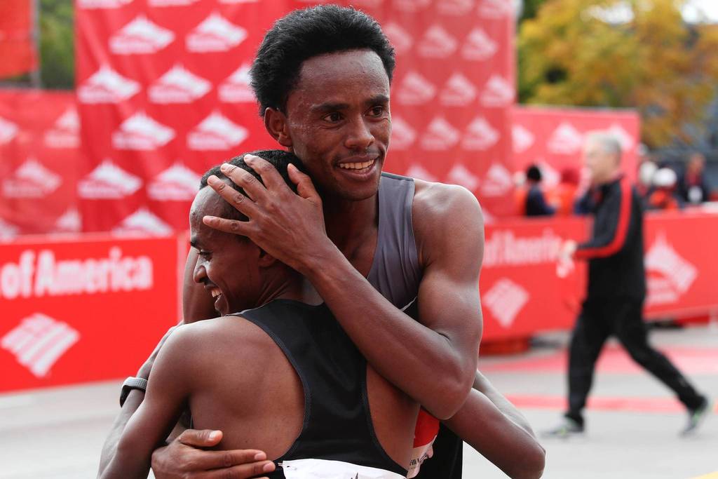 Tsegaye Kebede, front, becomes the first Ethiopian to win the Bank of America Chicago Marathon, breaking the year-old course record by nearly a minute.