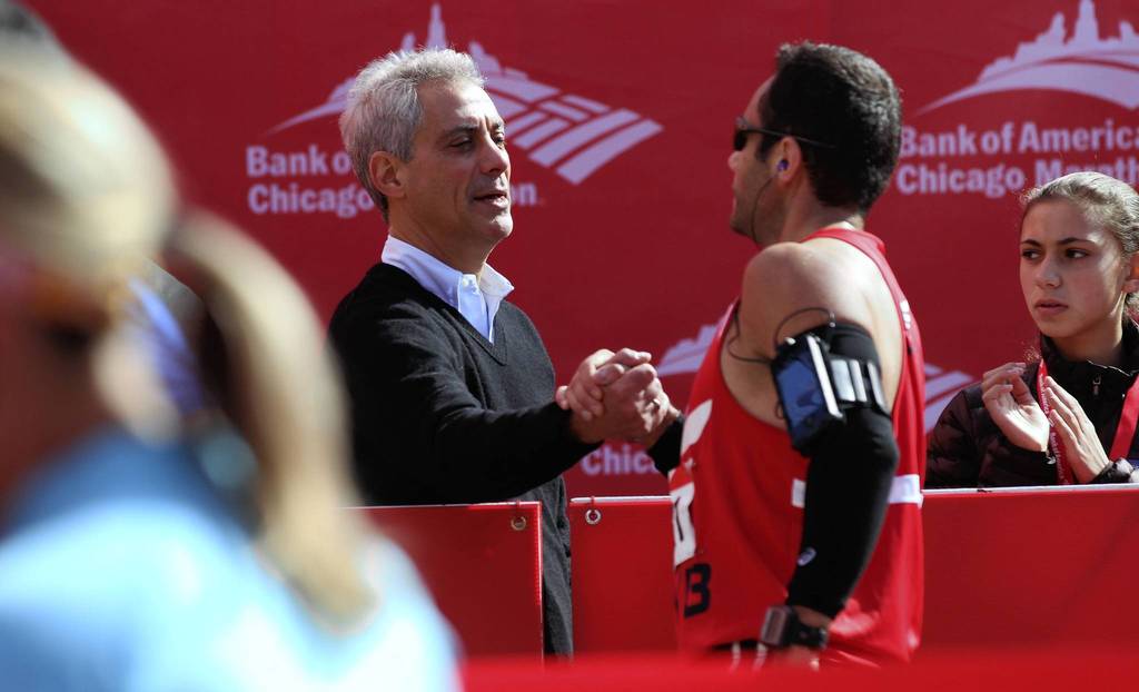 Chicago Mayor Rahm Emanuel congratulates runners at the 2012 Bank of America Chicago Marathon.