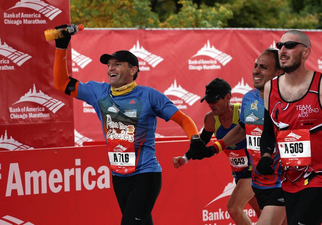 Runners celebrate crossing the finish line together on Columbus Drive at the Bank of America Chicago Marathon.