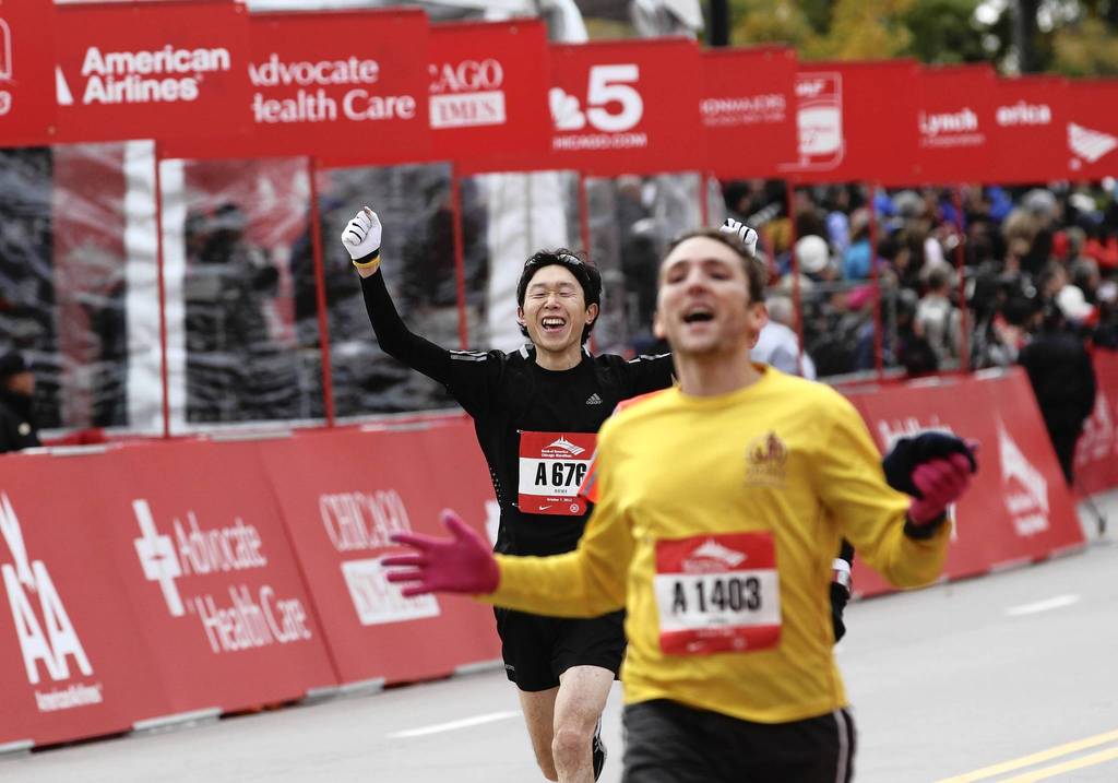 Runners celebrate crossing the finish line at the Bank of America Chicago Marathon.