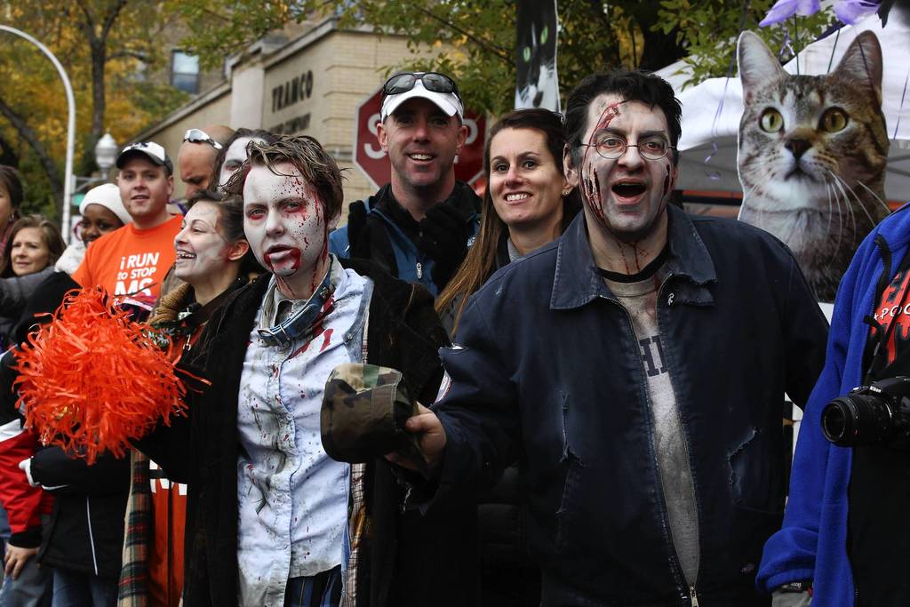 Fans dressed as zombies gather at Adams near Loomis to cheer on runners during the Chicago Marathon.