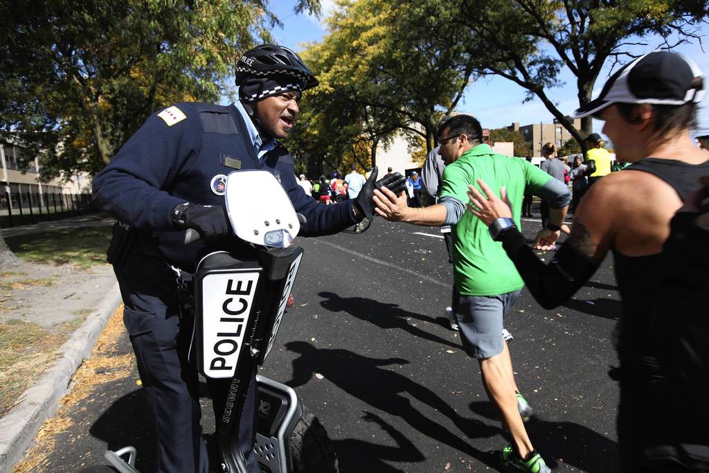 Chicago police officer Craig Williams encourages runners at the turn from 35th Street onto Michigan Avenue as they head towards the home stretch of the 35th Bank of America Chicago Marathon.