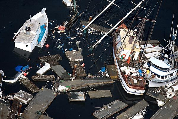 Boats and debris litter the harbor in Crescent City.