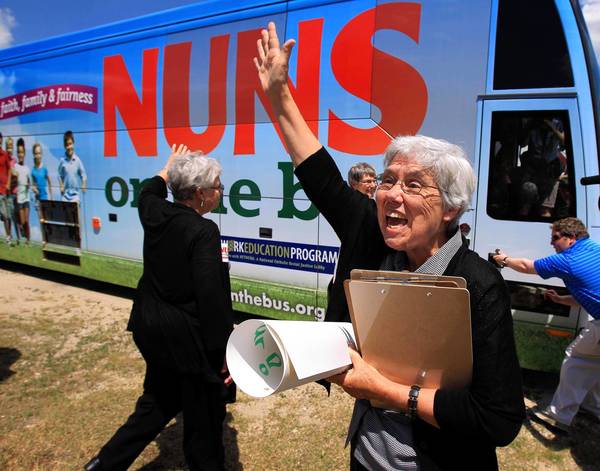Sister Mary Wendlen waves to supporters Wednesday in Fox Lake, where she and three other nuns visited the headquarters of Republican U.S. Rep. Joe Walsh, to scold Walsh for voting on a House budget the sisters say threatens to hurt the people they serve.