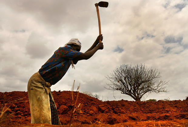 A farmer digs a trench in Kenya's Mwingi district, hoping to capture any rainwater that might come. As the world's population grows, researchers say, it will be increasingly difficult to produce enough food to feed everyone. (Rick Loomis / Los Angeles Times)