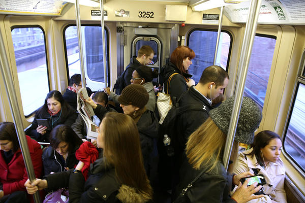 Photo of people riding the CTA in Chicago.