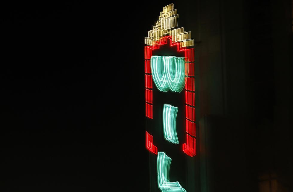 The neon marquee of the Wiltern, a landmark Art Deco theater, glows over the intersection of Wilshire Boulevard and Western Avenue. (Luis Sinco / Los Angeles Times)