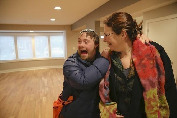 Jacob Mosbacher, 25, is excited to show his mom, Joan Katz, his new home last month as he and other clients of the Libenu home check out the special-needs house in Chicago's West Rogers Park.
