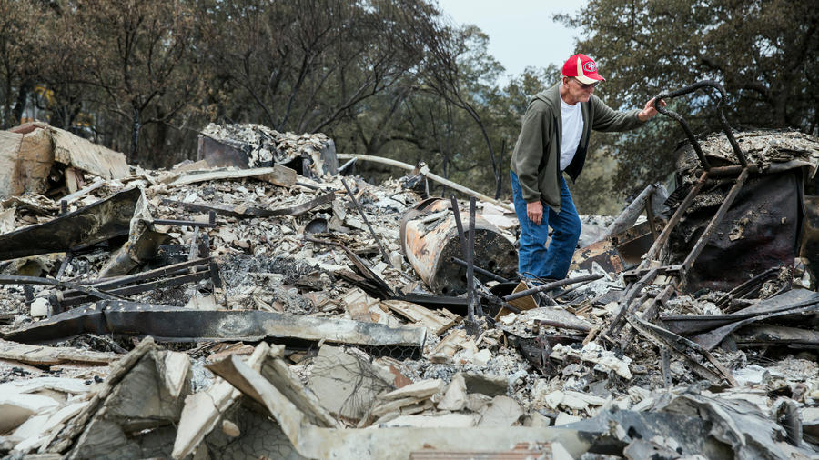 Jay Albertson searches through the rubble of his home of 30 years after it was burned by the Valley fire in Hidden Valley Lake, Calif. 