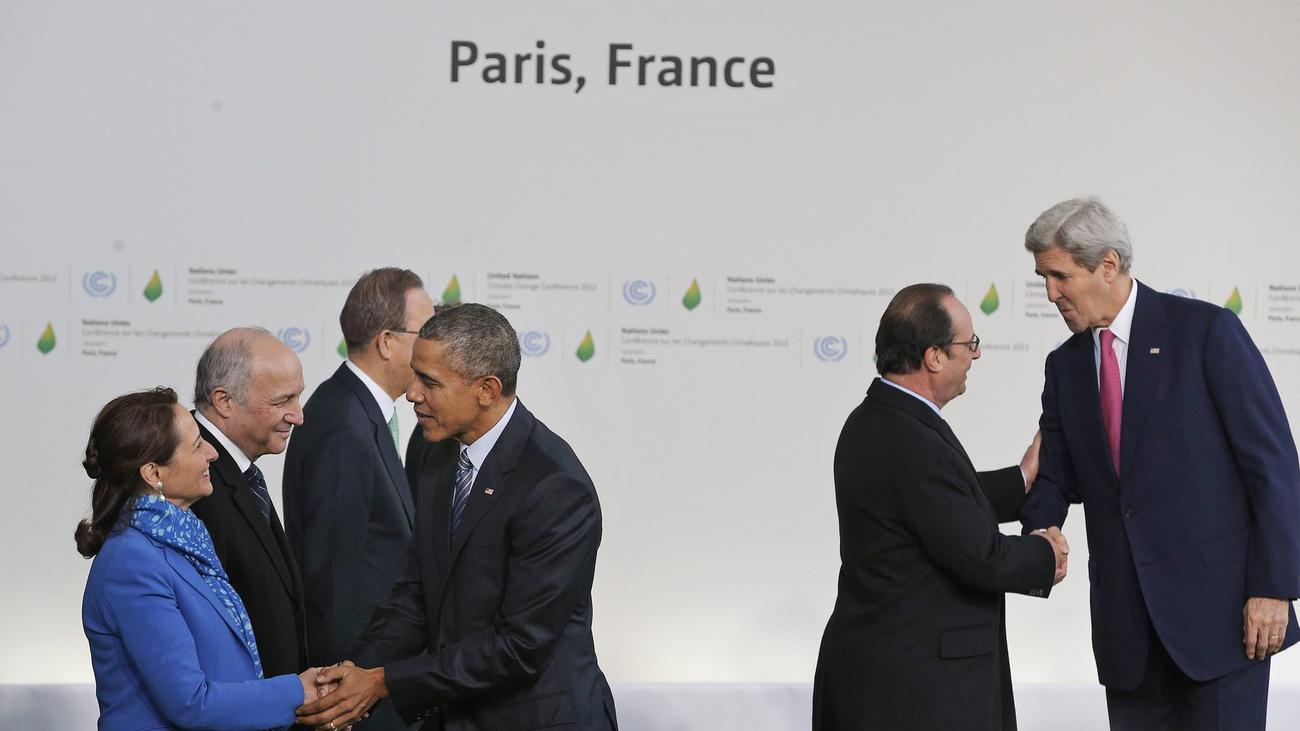 President Obama is greeted by Segolene Royal, left, French minister for ecology, sustainable development and energy, and Secretary of State John Kerry is greeted by French President Francois Hollande as they arrive in Paris on Nov. 30 for the climate change conference. (Christophe Ena / European Pressphoto Agency)