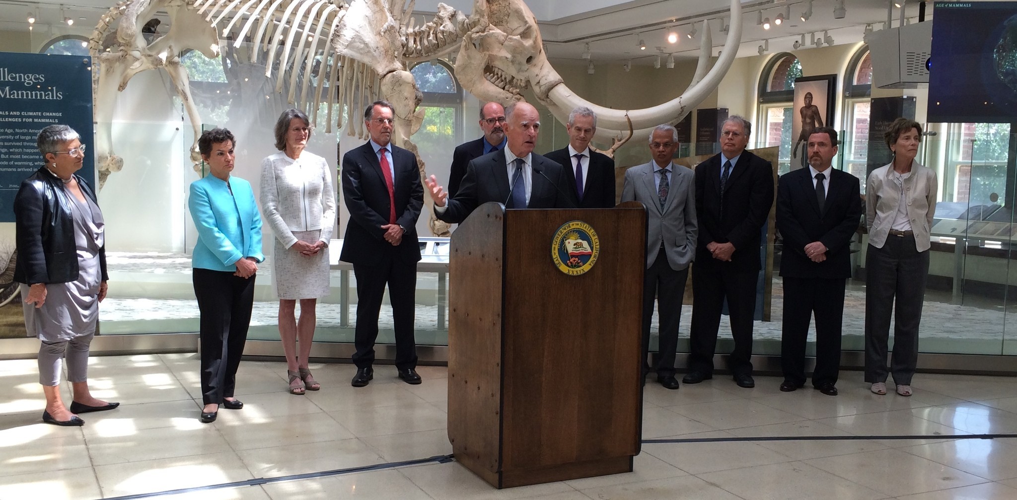 Gov. Jerry Brown with several scientists, including Mary Nichols, chair of the California Air Resources Board, far left, and Christiana Figueres, the top United Nations official on climate change, second from left, at the Natural History Museum in Los Angeles in June.  (Samer Momani / Caltrans)