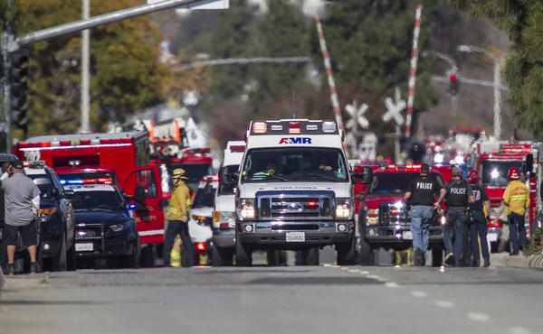 Ambulances leave the shooting scene last week. (Gina Ferrazzi / Los Angeles Times)
