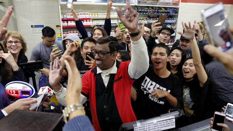 Residents of Chino Hills crowd into a 7-Eleven, where one of the winning tickets of a record Powerball jackpot was sold. Employee M. Faroqui, center, sold the winning ticket.