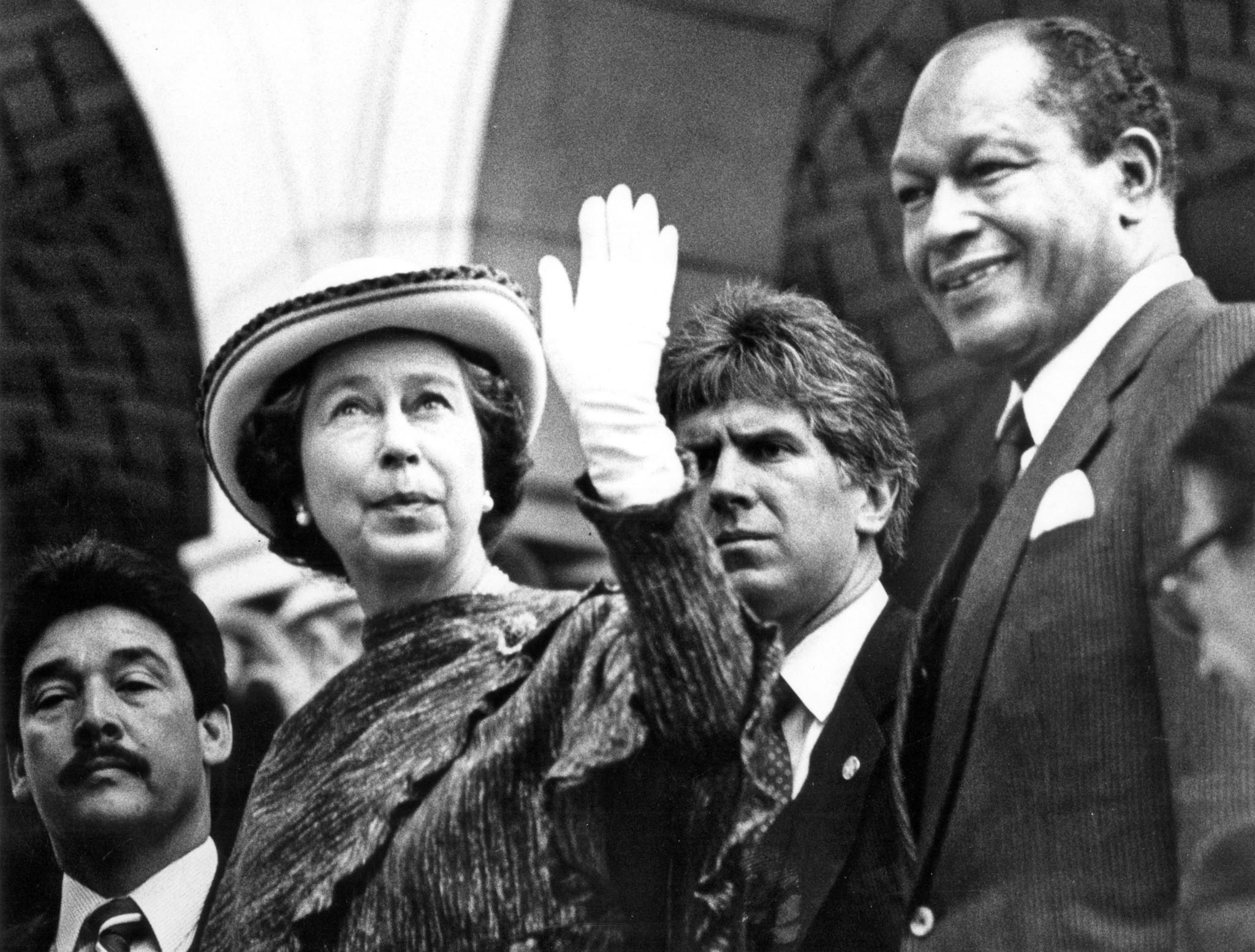 Feb. 28, 1983: Queen Elizabeth II waves to a crowd while being escorted into Los Angeles City Hall by Mayor Tom Bradley. This photo was published in the March 1, 1983, Los Angeles Times.