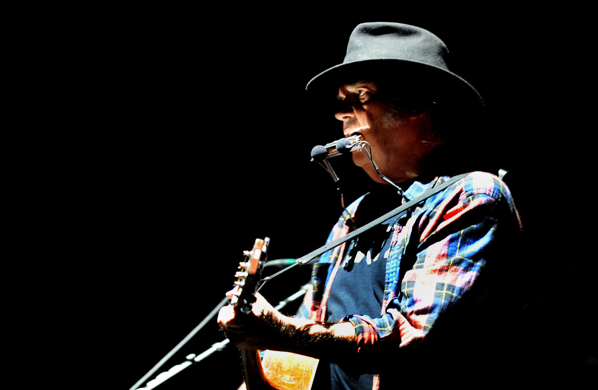 Neil Young performing in 2015 at the Forum in Inglewood.