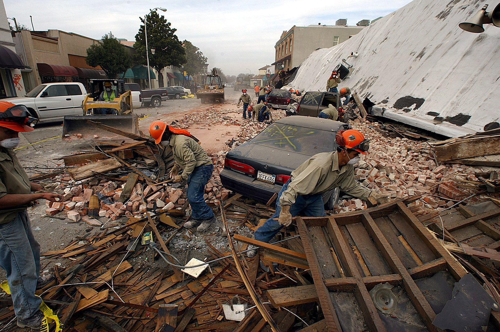 Rescue workers sift through the debris of an unretrofitted brick building in the wake of the 2003 Paso Robles earthquake. Two women who worked in the building died as they tried to flee.