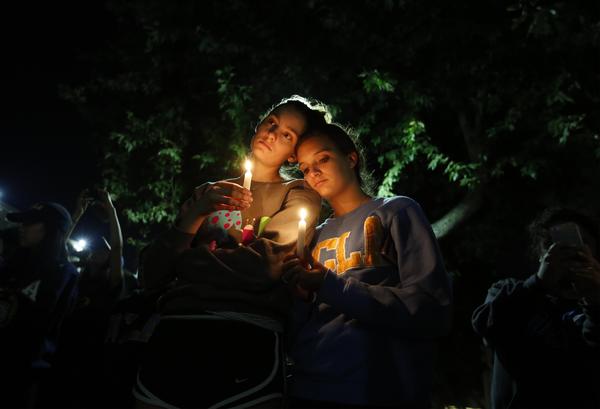 Aly Dembry, 18, an aerospace engineering student, and Rebecca Hambalek, 20, a pre-psychology student, joined hundreds of others at UCLA for a candlelight vigil. (Barbara Davidson/Los Angeles Times)