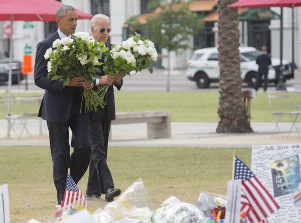 President Obama and Vice President Joe Biden place flowers for the shooting victims at a memorial at the Dr. Phillips Center for the Performing Arts in Orlando, Fla., on June 16, 2016. (SAUL LOEBSAUL/AFP/Getty Images)