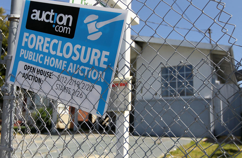 A foreclosure sign hangs on a fence in front of a foreclosed home in Richmond in 2011.