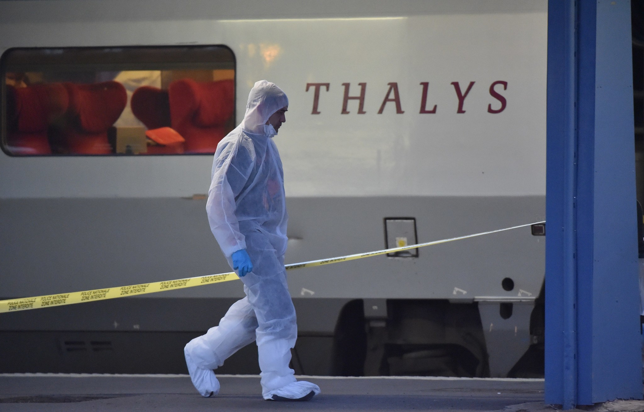 Police walk on a platform next to a Thalys train of French national railway operator SNCF in Arras, after a gunman opened fire on a train traveling from Amsterdam to Paris.