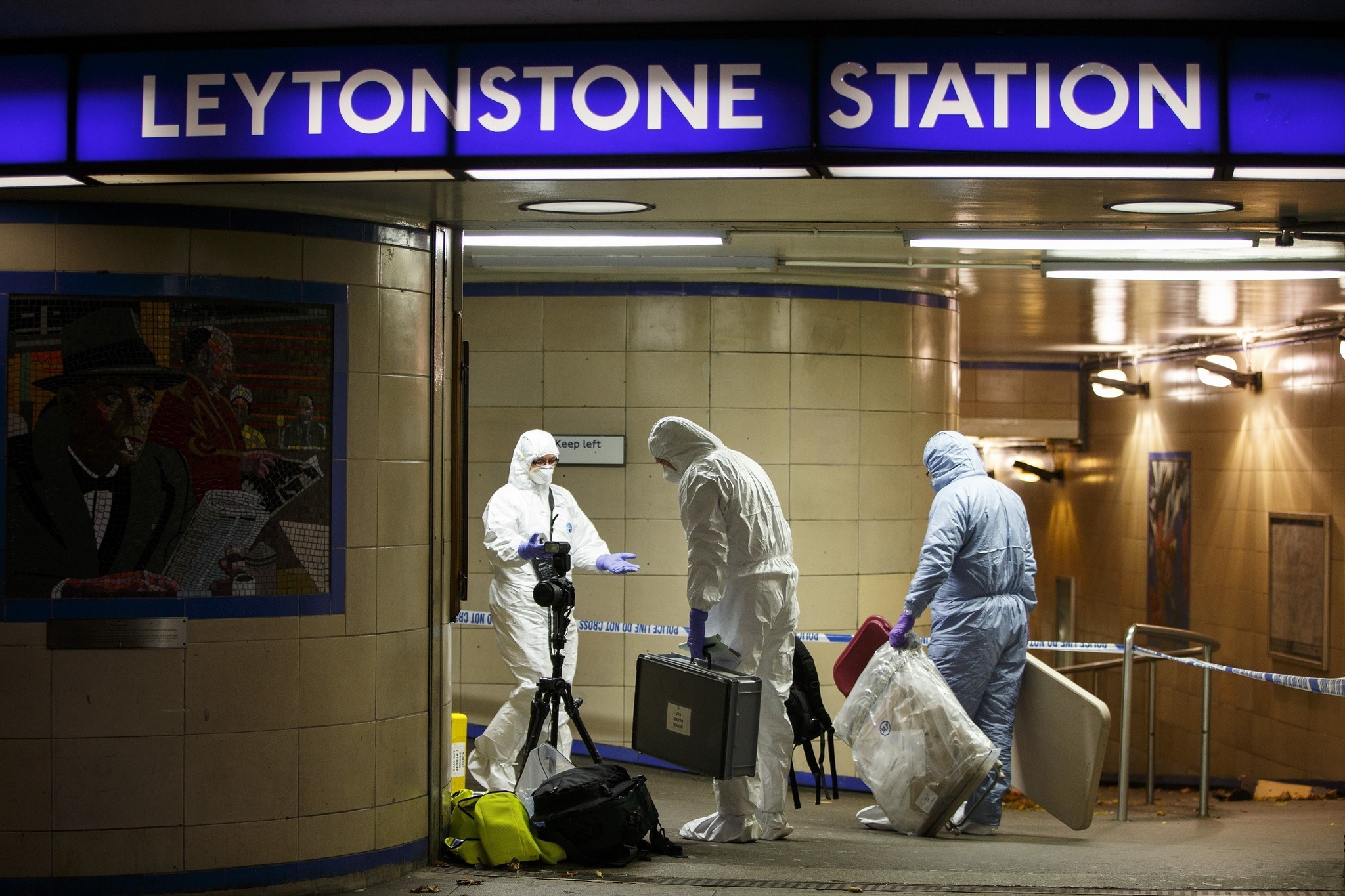 Crime scene investigators collect evidence at Leytonstone tube station in east London.