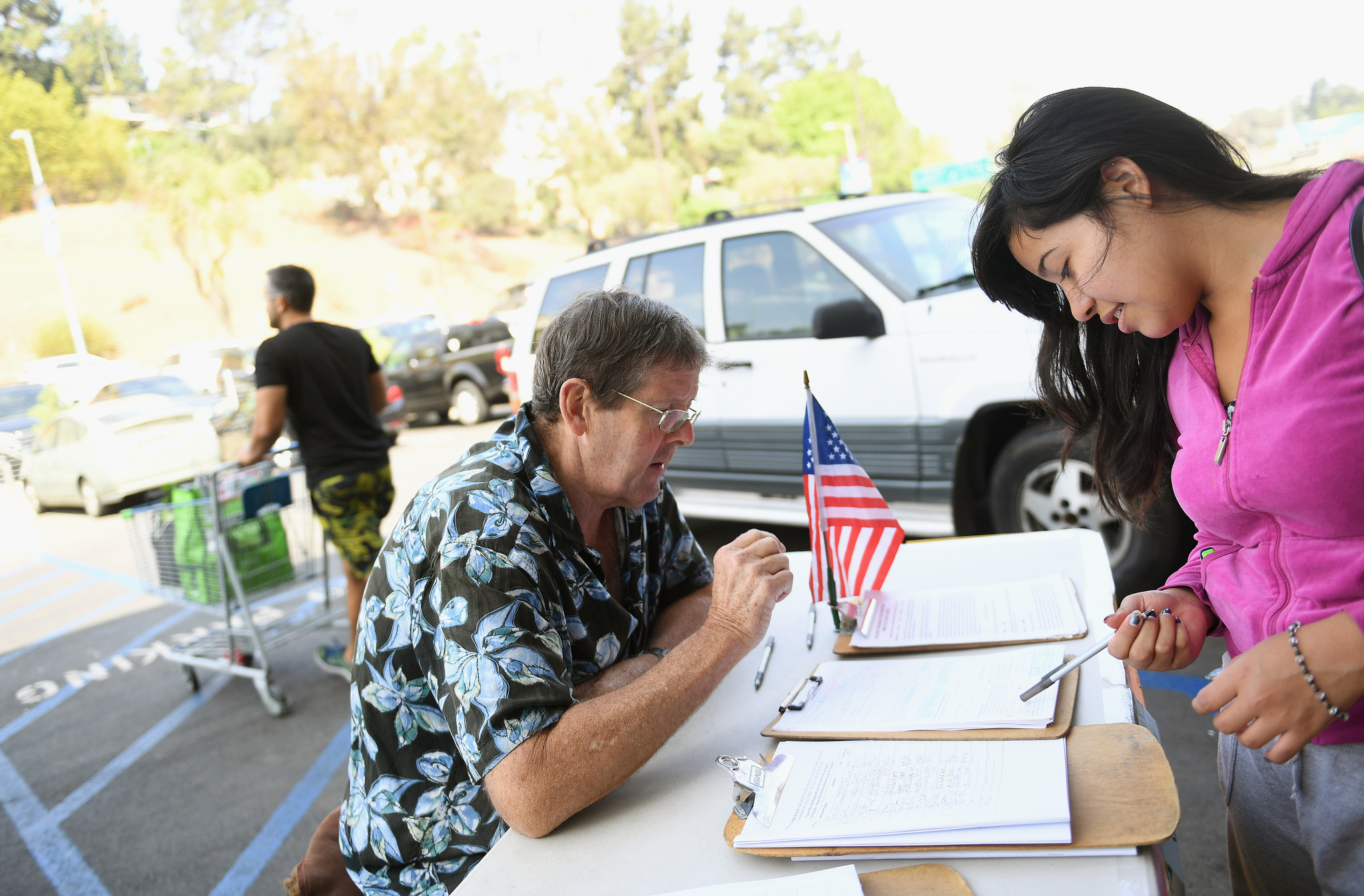 Tim Ecker collects signatures from Antonia Lopez, 19, in Silver Lake. Ecker says he made as much as $3,000 a week during peak season this year.
