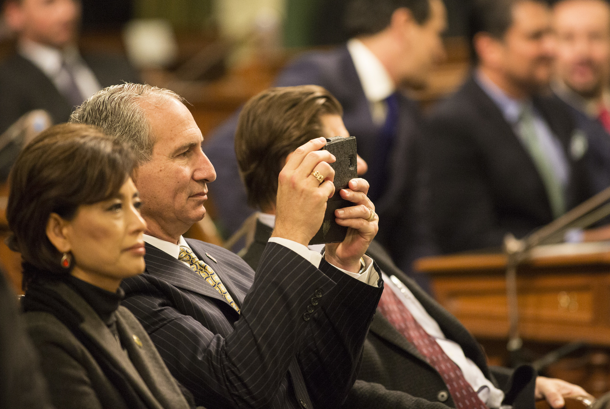 State Sen. Jeff Stone takes photographs during Gov. Jerry Brown's 2016 State of the State address.