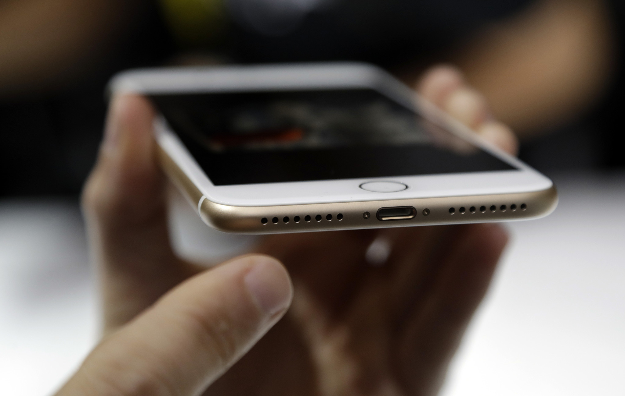 The new iPhone will use the lightning port for both charging and listening. (Marcio Jose Sanchez/Associated Press)