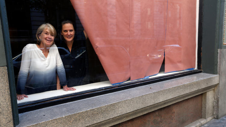 Artists Suzanne Lacy (left) and Andrea Bowers in the windows of the Main Museum in downtown L.A.