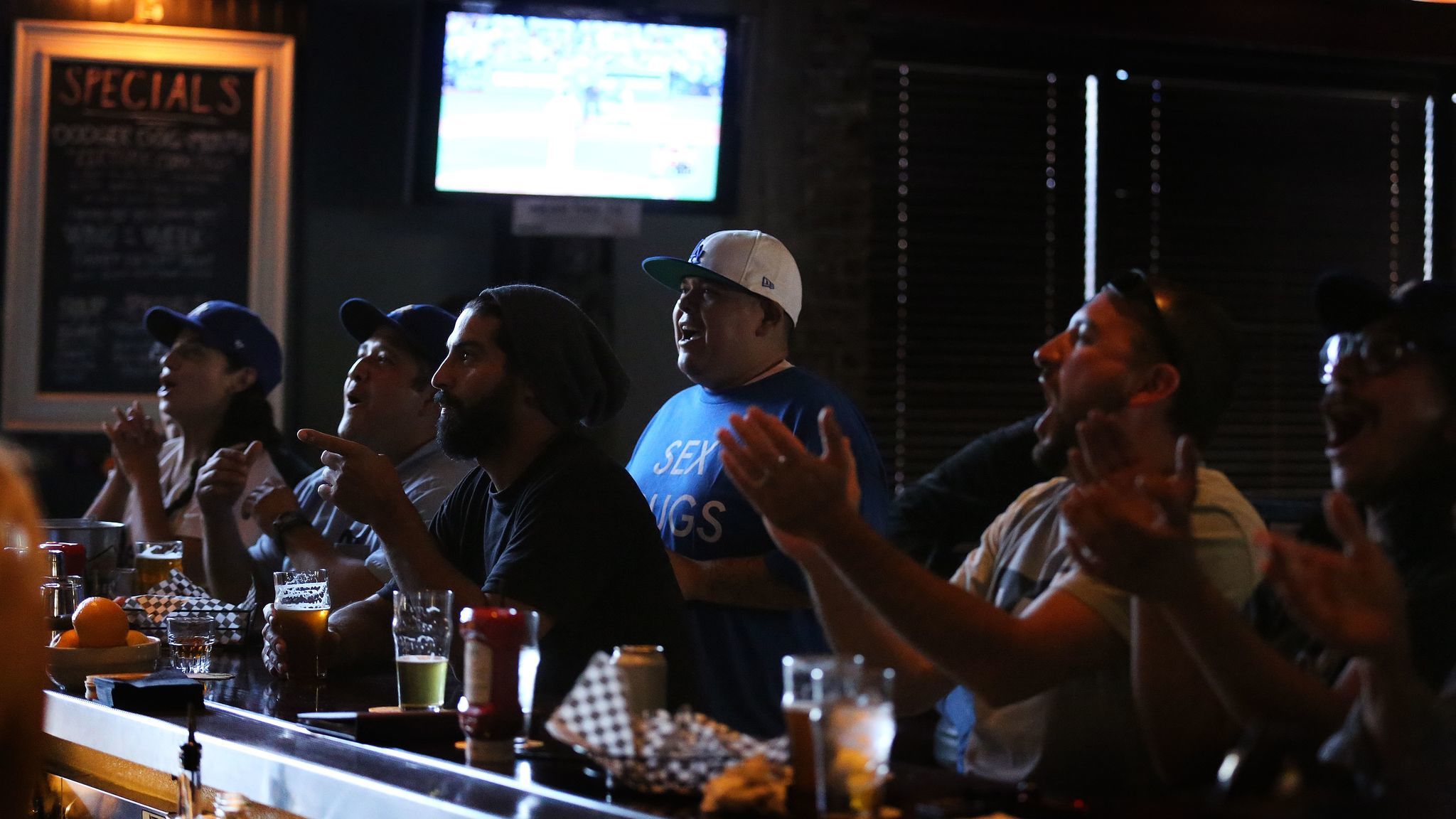 Fans enjoy a game and beers inside the Greyhound Bar & Grill in Los Angeles.