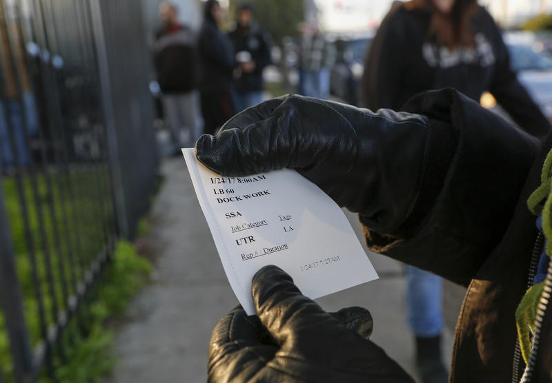 A worker shows a ticket with her assignment for the day.