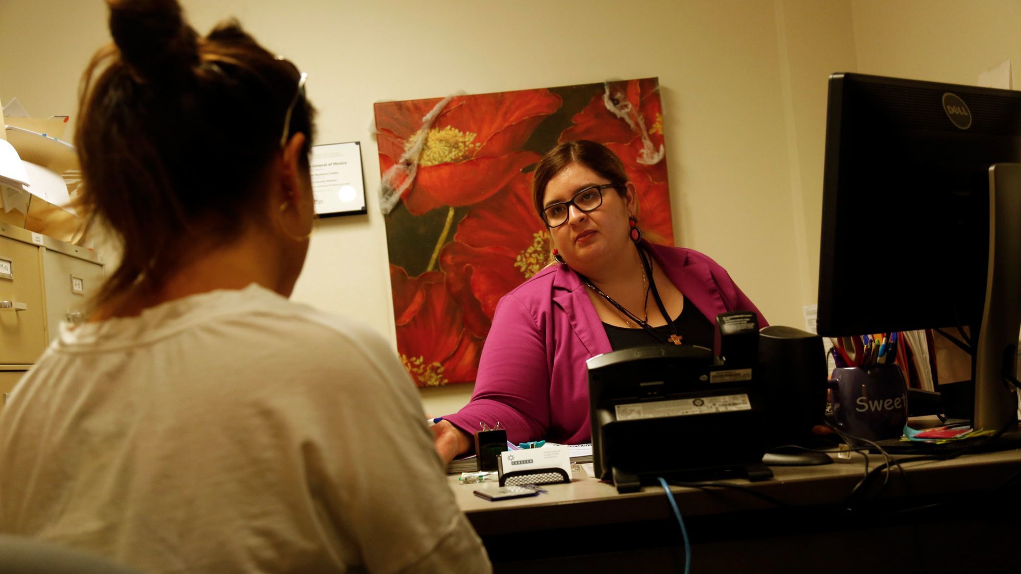 Maria meets with legal assistant Albanydia Amezquita, right, at the Central American Resource Center, which helped her obtain immigration relief through the U-visa program.
